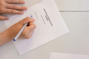person selecting votes on white paper