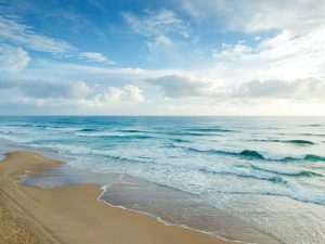 beach under blue and white sky