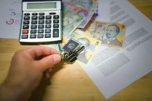 keys to new house on agreement documents household bills romanian currency