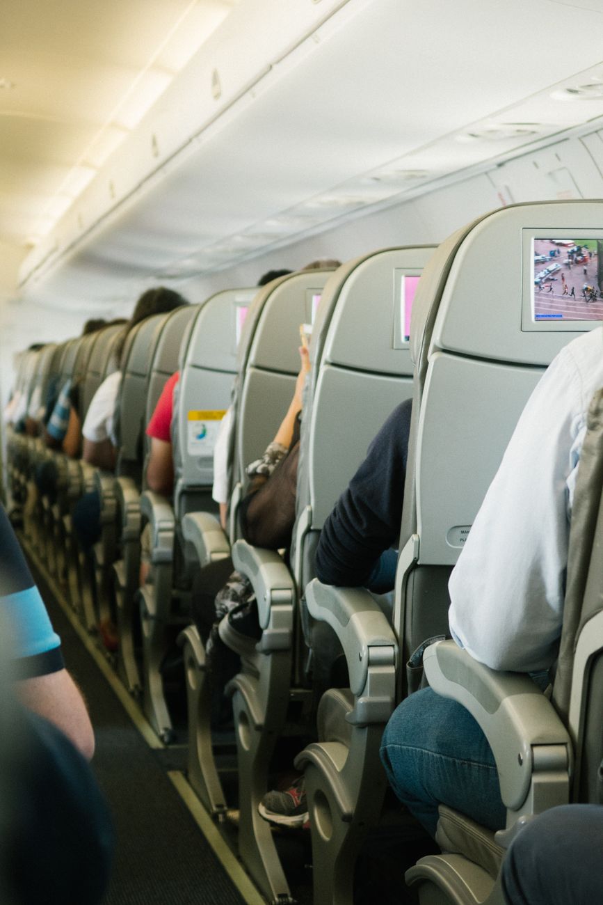 people sitting on plane chairs