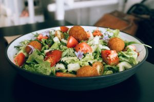 vegetable salad on black and white ceramic plate
