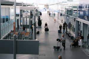 busy airport terminal with travelers and luggage